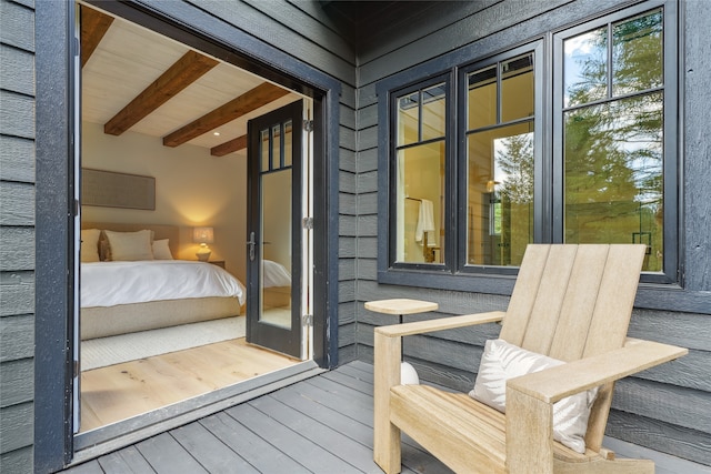 exterior space with beamed ceiling, wood ceiling, and wood-type flooring