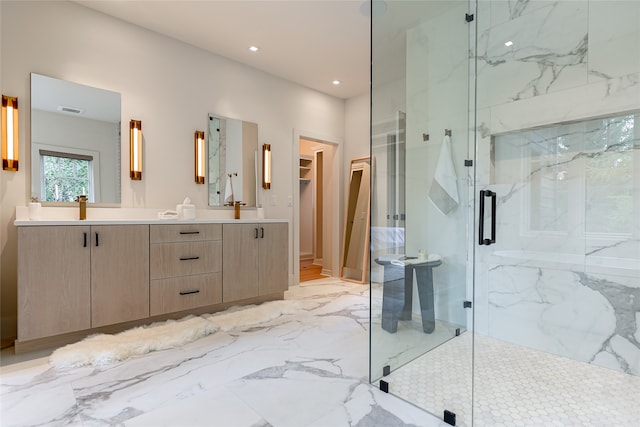 bathroom with vanity and a shower with shower door