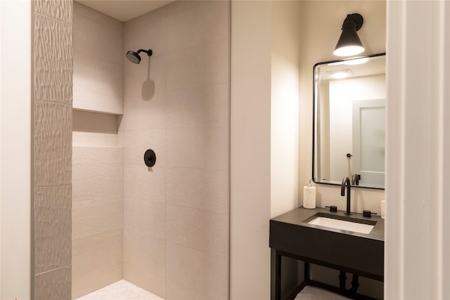 bathroom featuring vanity and a tile shower