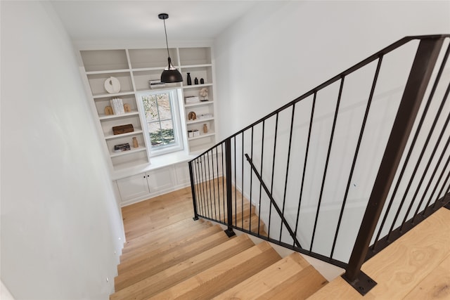 stairway with hardwood / wood-style flooring