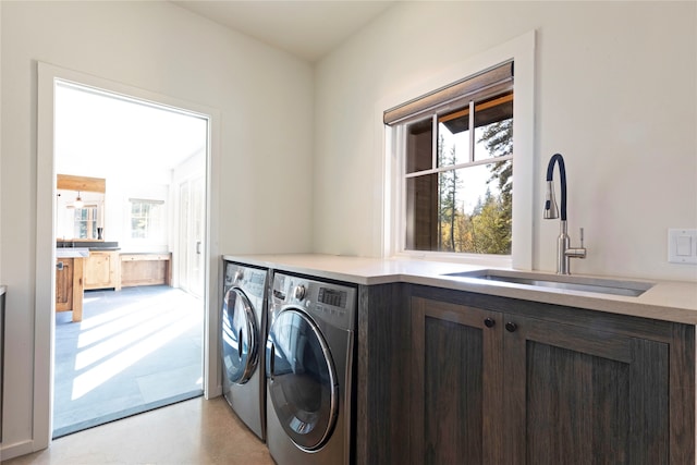 laundry area featuring washing machine and dryer and sink