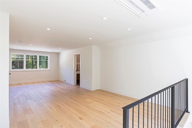 empty room with light hardwood / wood-style flooring