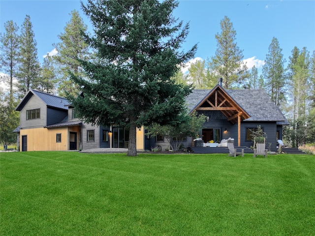 rear view of property featuring a yard