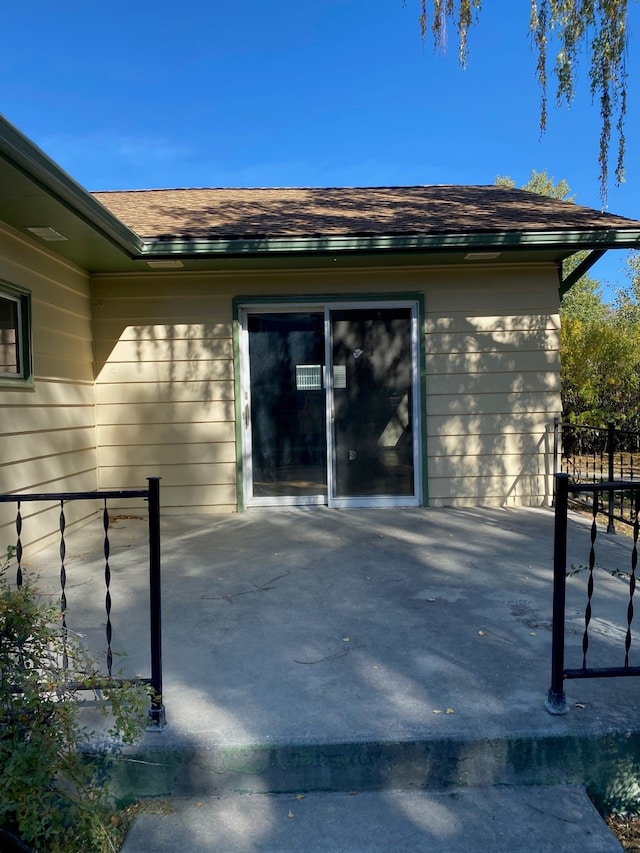 view of exterior entry with a patio