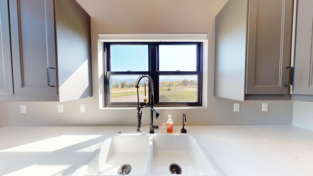 room details featuring gray cabinets and sink