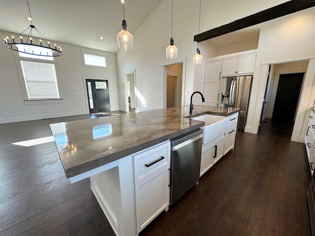 kitchen with white cabinetry, an island with sink, high vaulted ceiling, stainless steel appliances, and sink