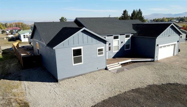 view of front of property featuring a mountain view and a garage