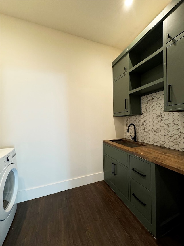 laundry room featuring cabinets, washer / dryer, dark wood-type flooring, and sink