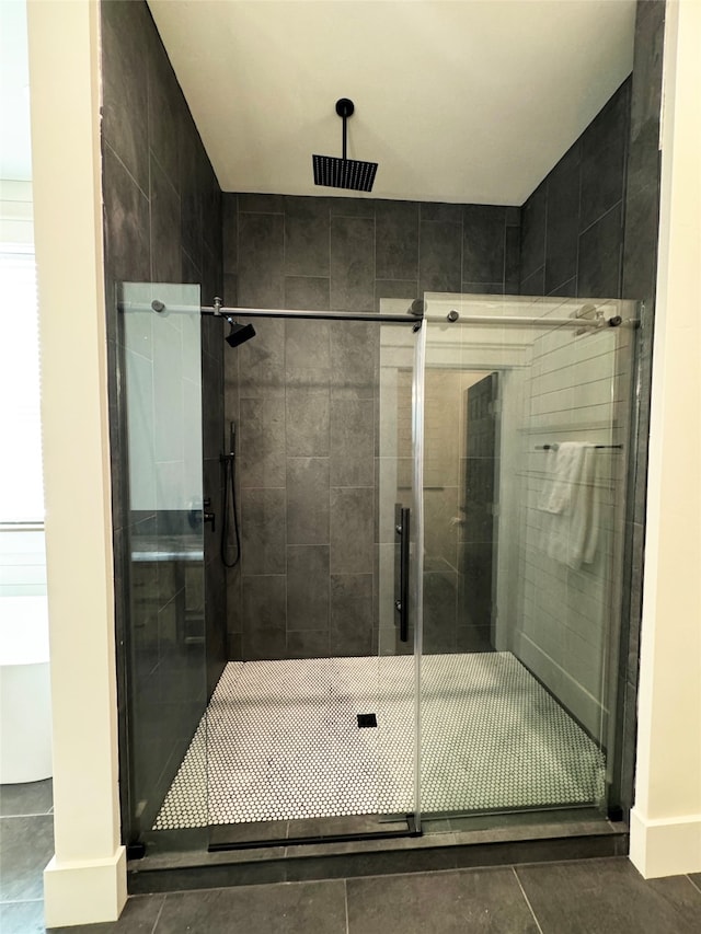 bathroom with tile patterned floors and a shower with shower door