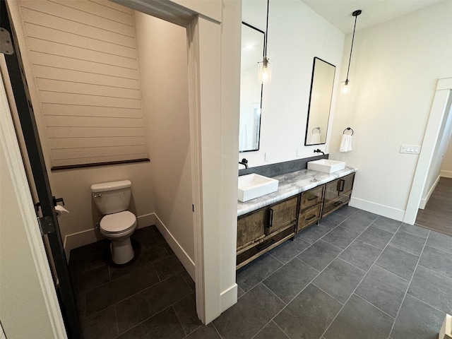 bathroom with tile patterned flooring, vanity, and toilet