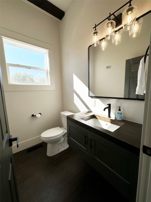 bathroom featuring vanity, toilet, and hardwood / wood-style flooring