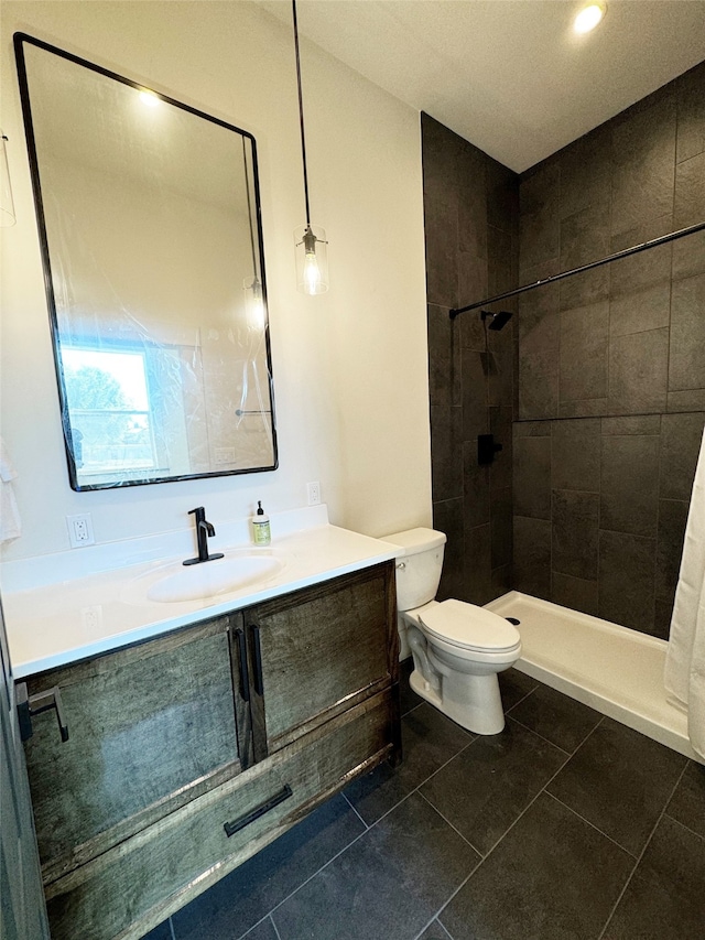 bathroom with curtained shower, vanity, toilet, and tile patterned floors