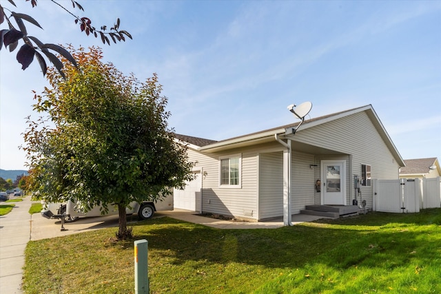 view of front of property featuring a garage and a front lawn