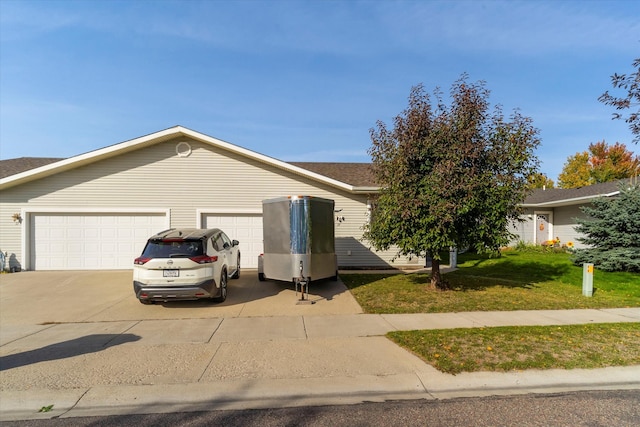 single story home with a front yard and a garage