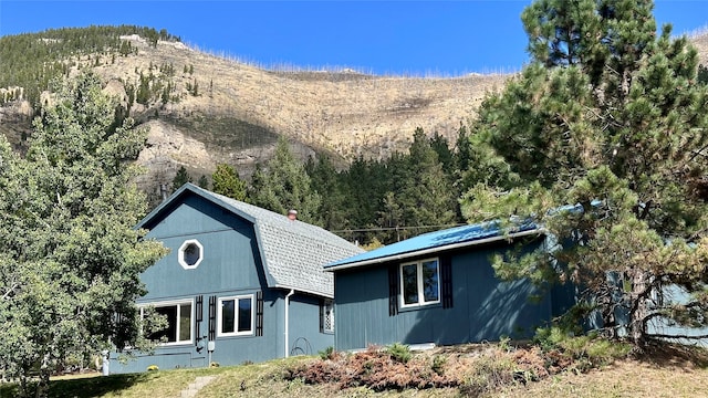 back of house with a mountain view