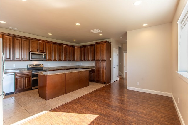 kitchen with light wood finished floors, recessed lighting, visible vents, and stainless steel appliances