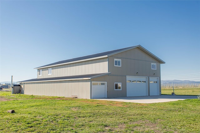 view of home's exterior featuring a yard and a detached garage