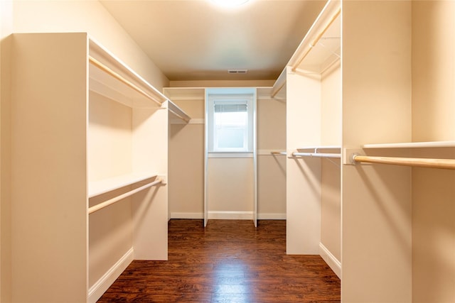 spacious closet featuring wood finished floors and visible vents