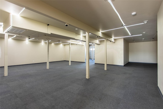 finished below grade area featuring dark colored carpet