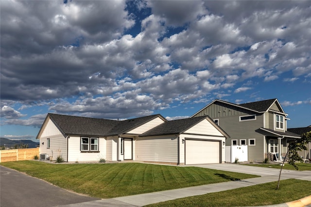 view of front of house featuring a garage, a front lawn, and central air condition unit