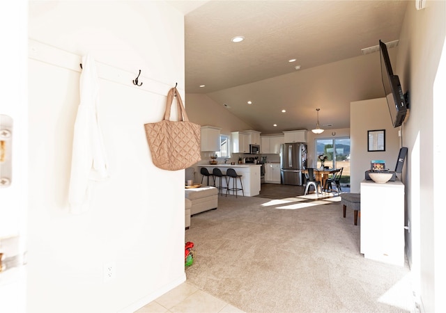 living room with lofted ceiling and light colored carpet