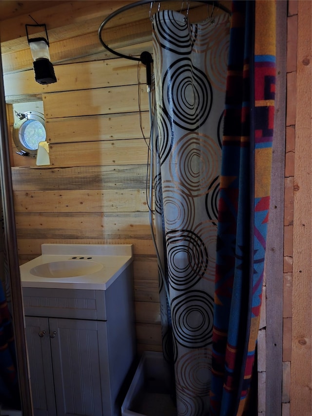 bathroom featuring vanity, hardwood / wood-style flooring, toilet, and wood walls