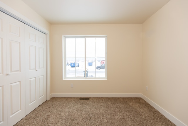 unfurnished bedroom featuring a closet and carpet floors