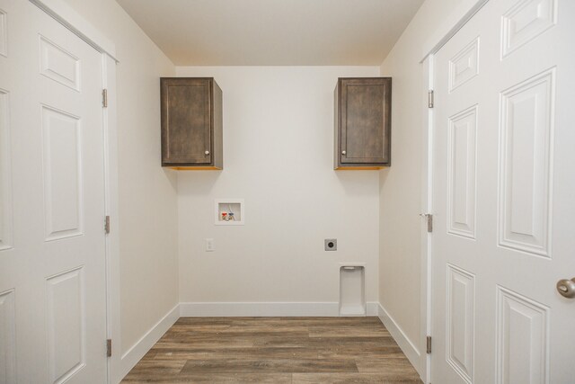 laundry area featuring washer hookup, cabinets, hookup for an electric dryer, and dark hardwood / wood-style floors