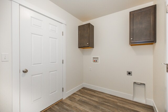 washroom with dark hardwood / wood-style floors, cabinets, electric dryer hookup, and hookup for a washing machine