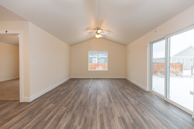 spare room with ceiling fan, dark wood-type flooring, and lofted ceiling