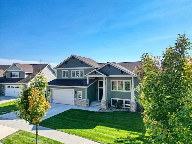 craftsman house featuring a front yard and a garage