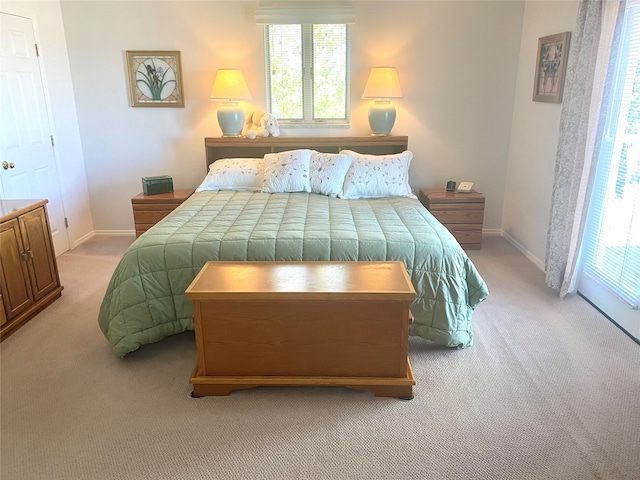 carpeted bedroom featuring multiple windows