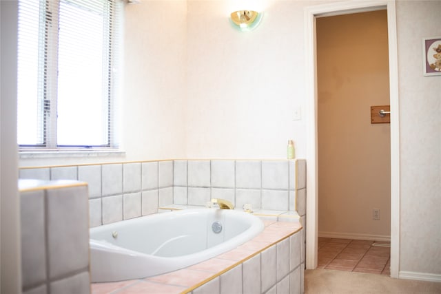 bathroom with tile patterned floors and a relaxing tiled tub