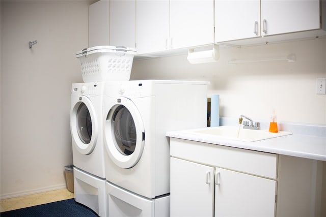 washroom featuring cabinets, separate washer and dryer, and sink