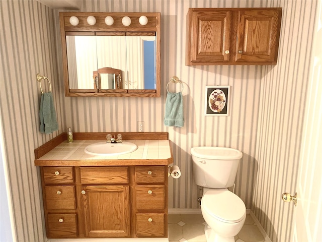 bathroom featuring tile patterned floors, vanity, and toilet