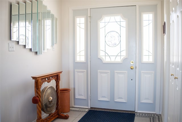 tiled foyer featuring a healthy amount of sunlight