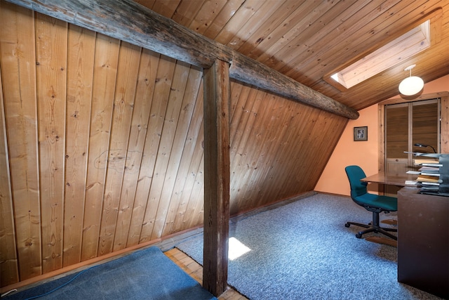 unfurnished office with carpet flooring, wood walls, lofted ceiling with skylight, and wooden ceiling