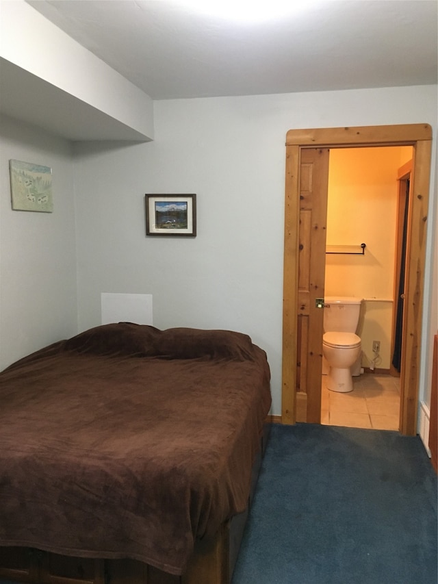 tiled bedroom featuring connected bathroom