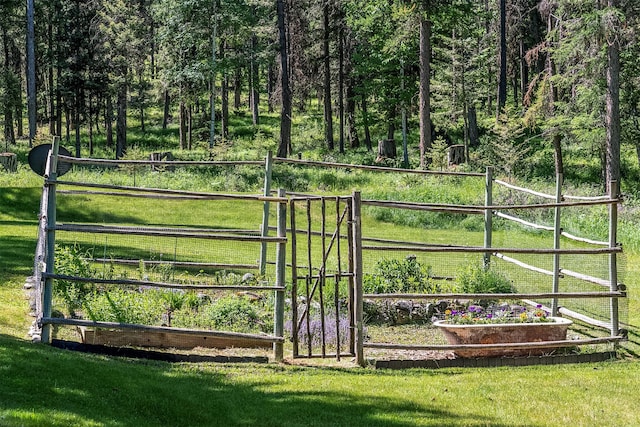 view of gate with a lawn