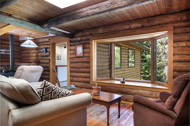 living room featuring wood ceiling, rustic walls, light hardwood / wood-style floors, and beamed ceiling