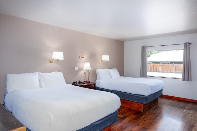 bedroom with dark hardwood / wood-style flooring