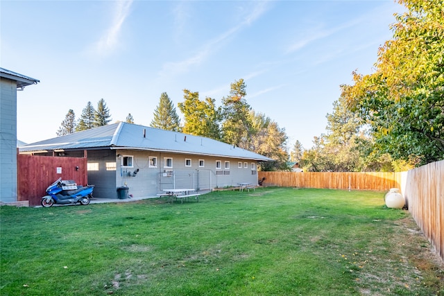 rear view of property with a lawn