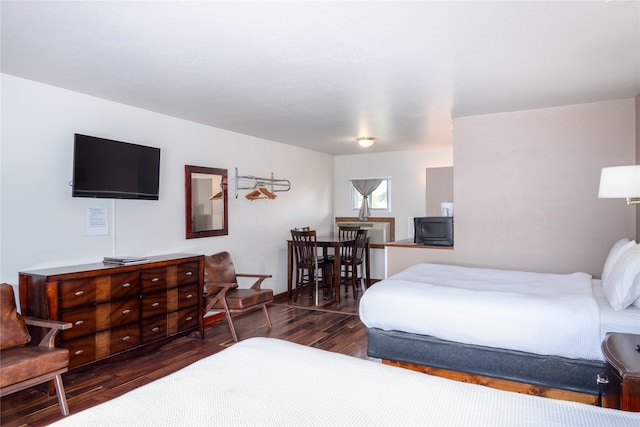 bedroom with dark hardwood / wood-style floors