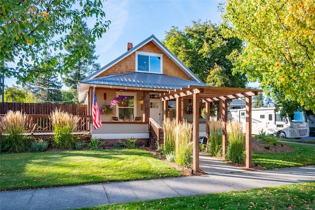 view of front of house with a pergola, covered porch, and a front yard