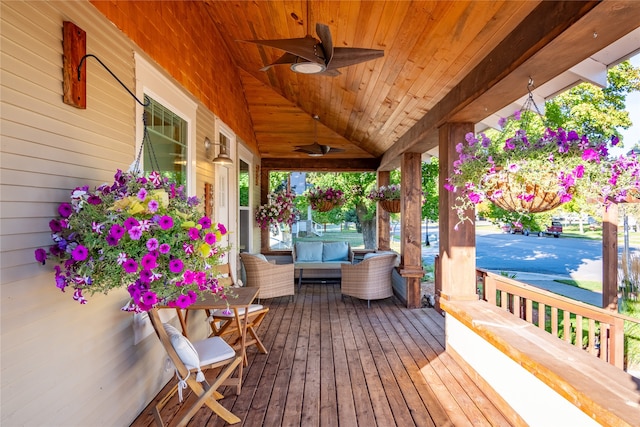 deck with ceiling fan and covered porch