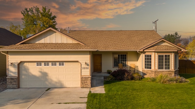 view of front facade featuring a garage and a lawn