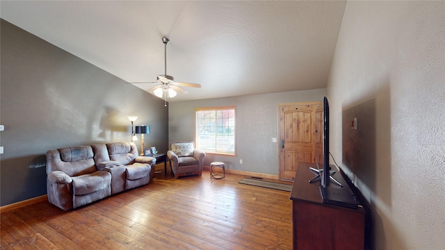 living room with ceiling fan, hardwood / wood-style flooring, and vaulted ceiling