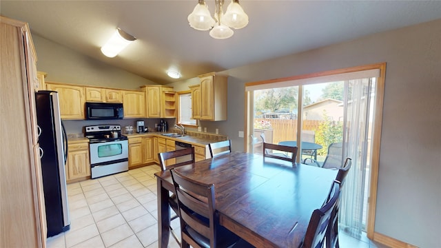 kitchen featuring light brown cabinets, lofted ceiling, hanging light fixtures, stainless steel fridge, and white range with electric stovetop