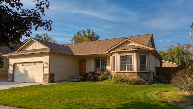 view of front of property with a garage and a front lawn