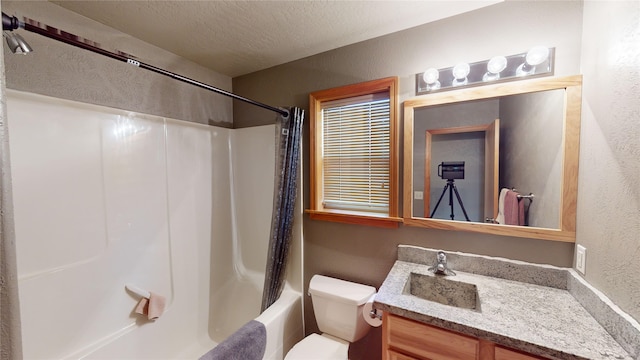 full bathroom with a textured ceiling, shower / bath combo, vanity, and toilet